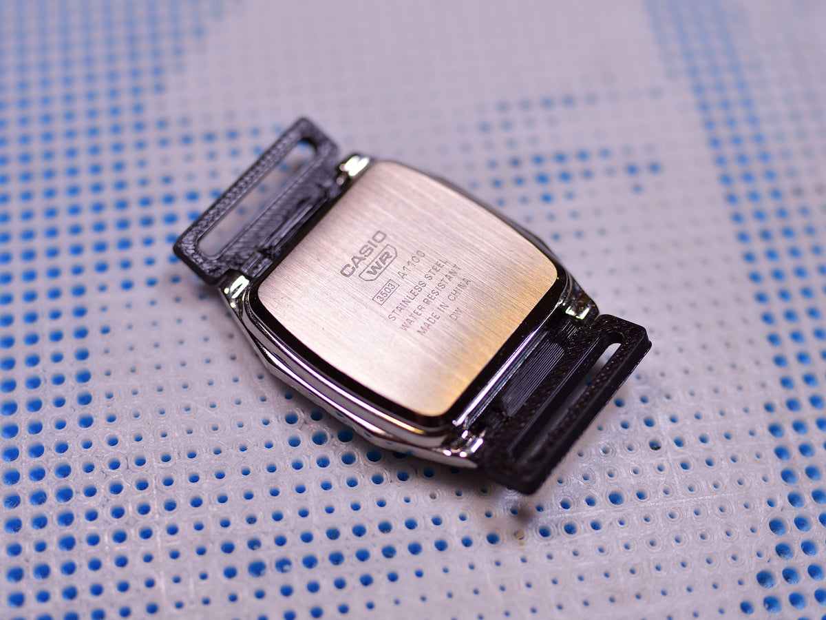 Casio AD1100D watch adapter, back view showing adapter fit