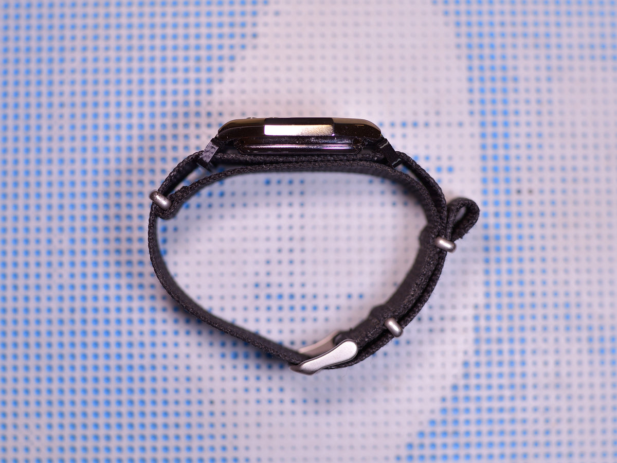 Casio AD1100D strap looped through adapter, side view